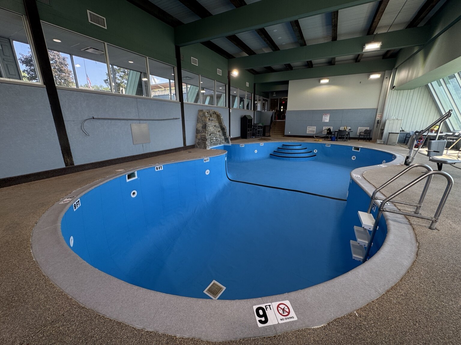 Completed Hueston Woods Lodge pool with Adriatic Blue membrane and Light Grey coping wrap