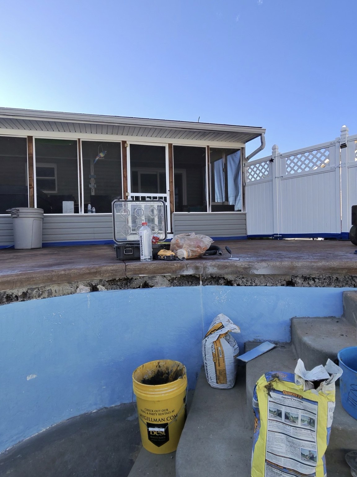 Cut-back fiberglass edge and exposed gap beneath the Millersburg pool deck