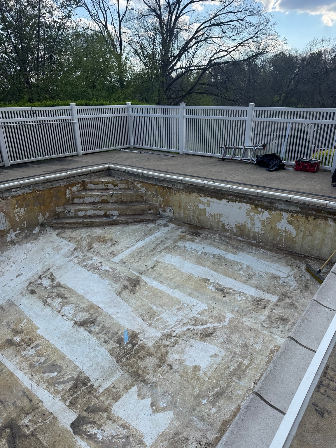 Worn concrete steps and walls exposed at the Pittsburgh pool