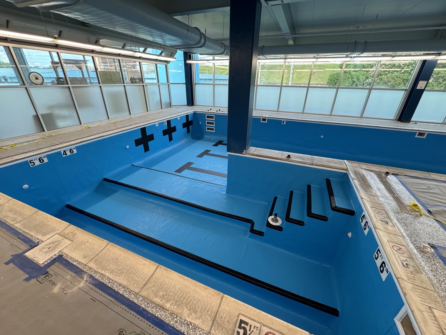 Completed deep area of the Siskin rehabilitation pool with reinforced PVC membrane and safety markings